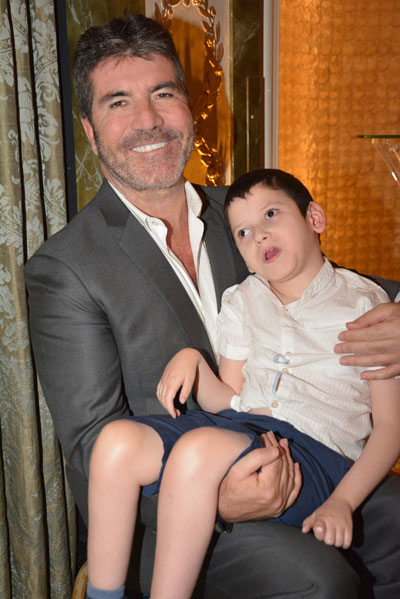 Simon-Cowell-with-supported-child,-Freddie